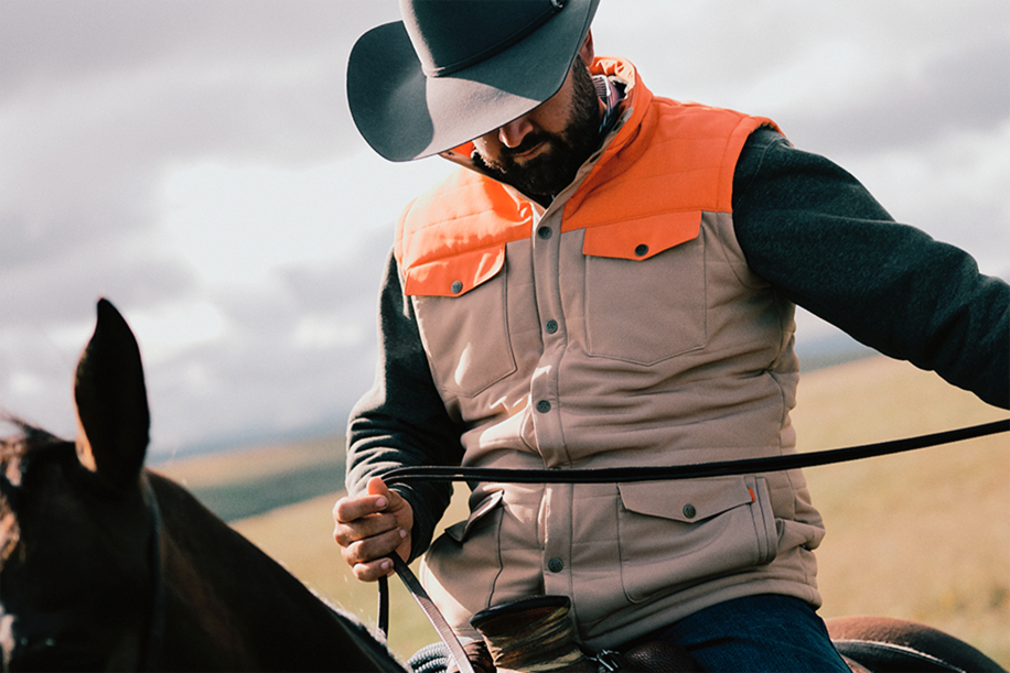 Man on horse wearing King Ranch Vest