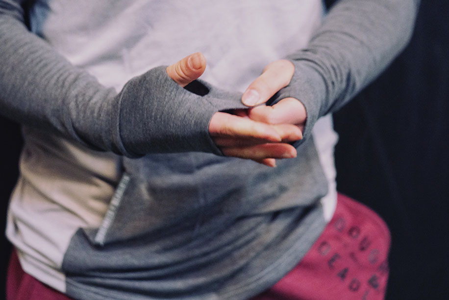 man in grey hoodie with thumbholes