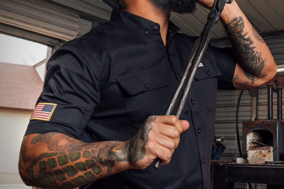 Man in shortsleeve buttondown with american flag on sleeve