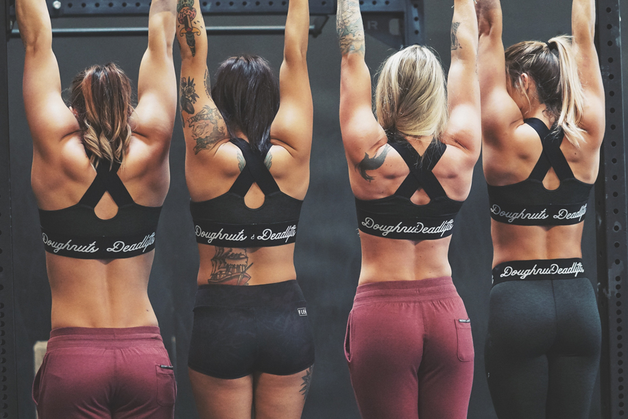 Women doing pullups in Doughnuts And Deadlifts Sports bra and leggings