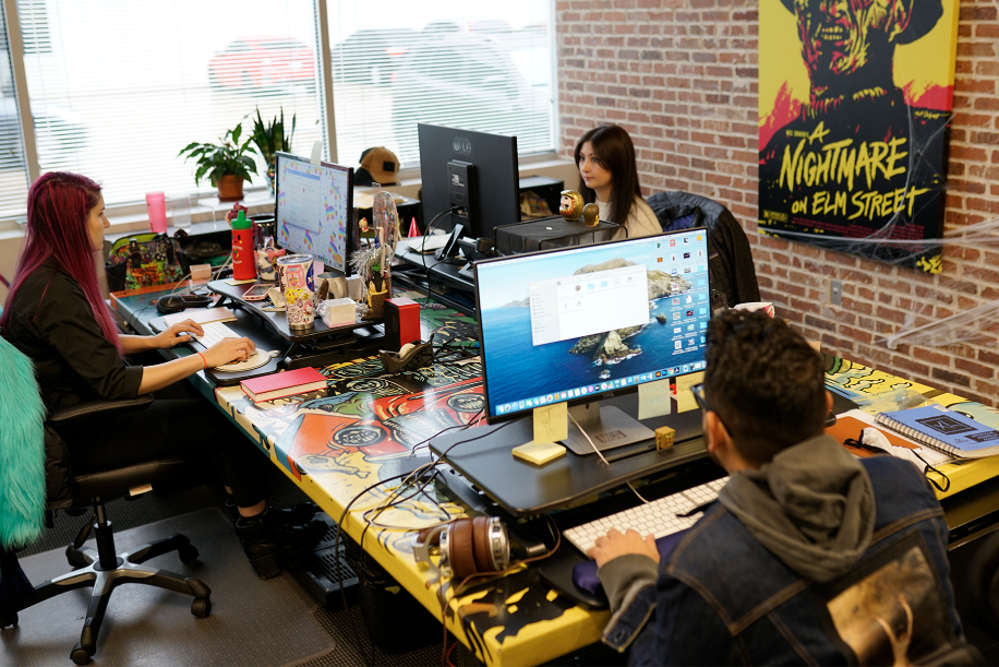 3 Pinpoint team members at work at table