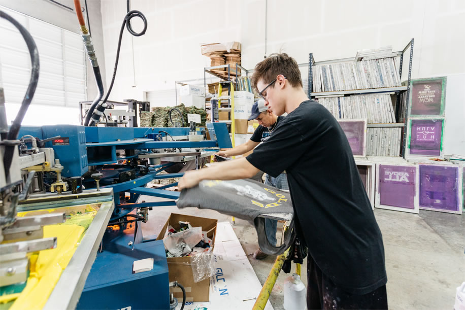 Man working with screen printing machine